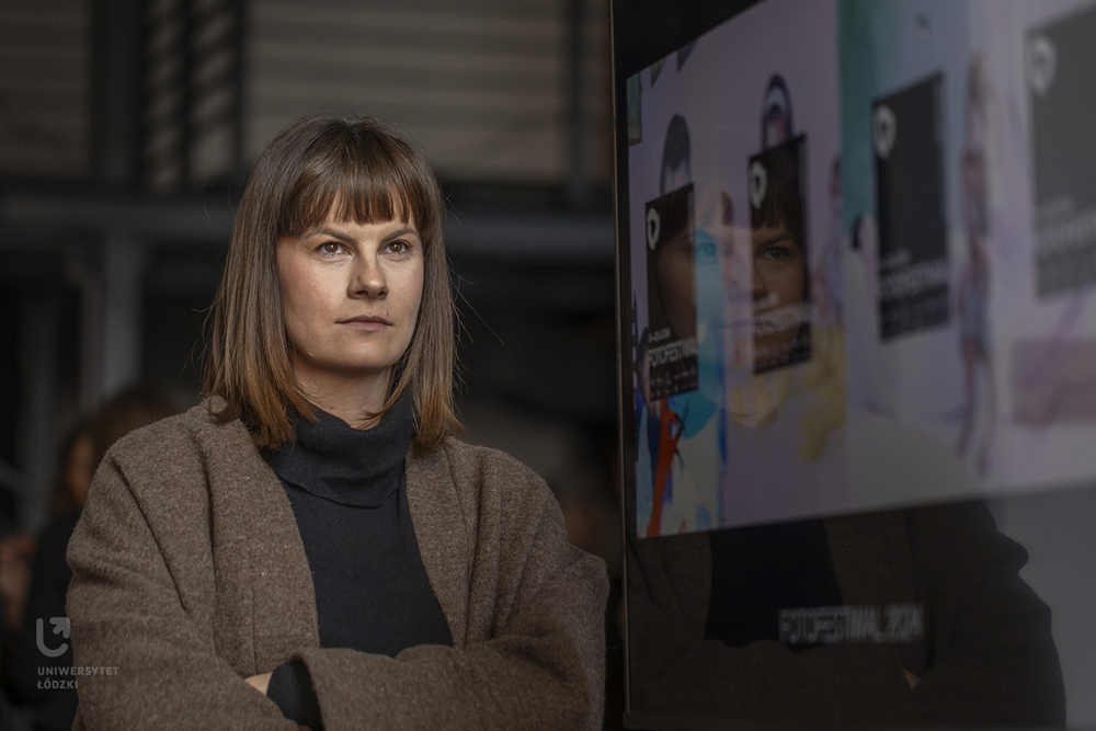 Dagmara Bugaj, a brown-haired woman standing by the screen